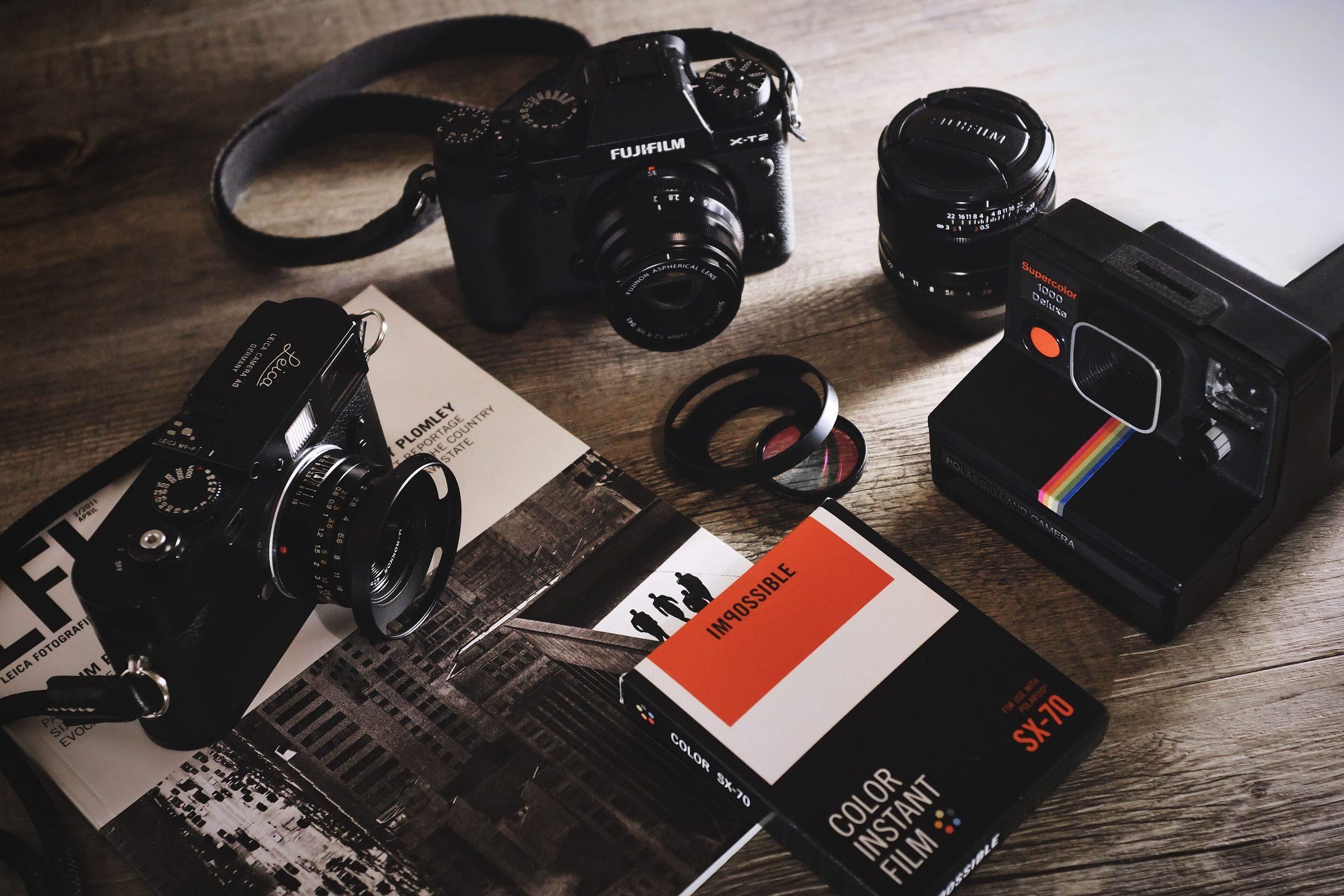 Film cameras and lenses laid out on a table